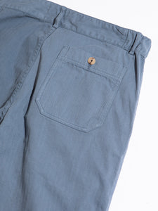 The back pocket of a classic pair of men's workwear trousers, in blue.