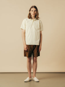 A man wearing a short sleeve shirt and a pair of shorts from KESTIN.