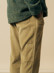 The side detail of a pair of men's classic carpenter pants in green corduroy.