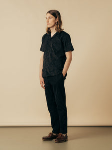 A model wearing a pair of slim chinos and a paisley shirt from KESTIN.