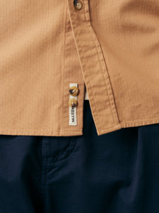 The hem and logo patch from the KESTIN Dirleton Shirt in Terracotta.