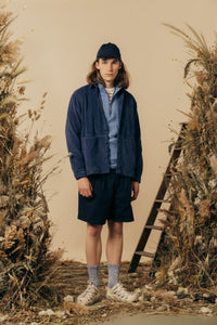 A man wearing a layered spring outfit by Scottish designer KESTIN.
