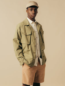 A model wearing a shirt and a fatigue jacket from menswear brand KESTIN.