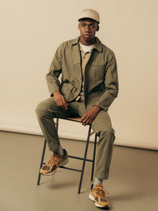 A model sitting on a stool, wearing a smart outfit from premium menswear brand KESTIN.