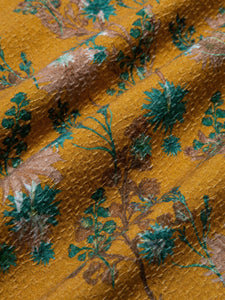 A textured cotton fabric in a yellow floral print, used to make the KESTIN Crammond Shirt.