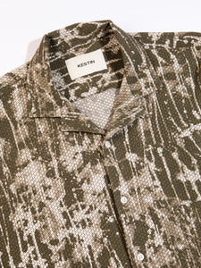 The buttoned front and camp collar of the KESTIN Crammond Shirt in Olive Camo.