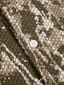 A woven green and white material, used to make a men's shirt by KESTIN.