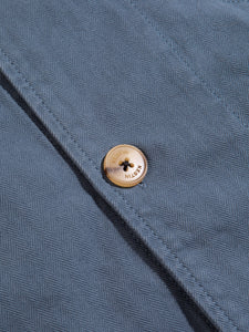 A branded KESTIN logo button on the Huntly Jacket in French Blue.