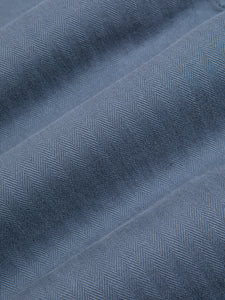 A blue cotton herringbone fabric, used to make a suit by menswear brand KESTIN.