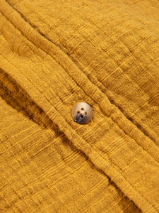 A close-up of the yellow fabric and button from the KESTIN Raeburn Shirt.
