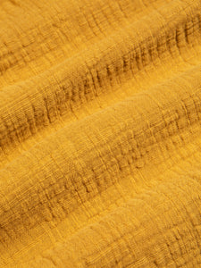 A loose, casual and textured yellow fabric, used for KESTIN's SS24 Collection.