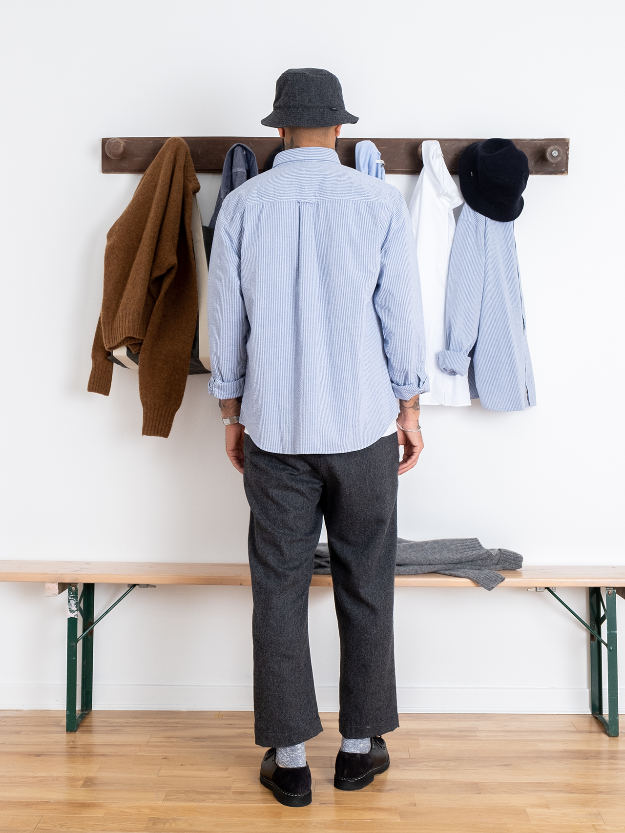 This model is showing off the back of the Raeburn Button Down Shirt by premium menswear brand KESTIN, made from a comfortable Seersucker with a blue stripe pattern.