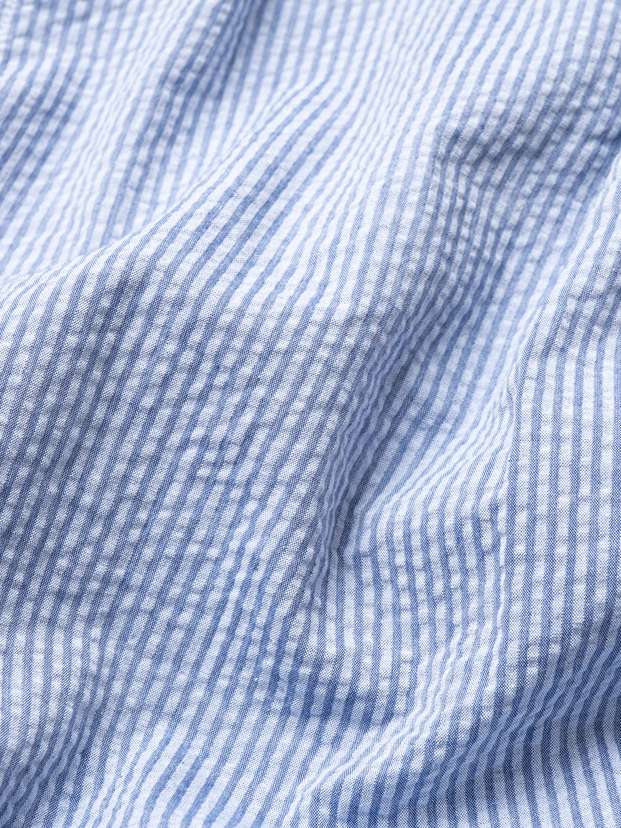 Men's blue striped Seersucker shirting material, used to make the KESTIN Raeburn Button Down Shirt.